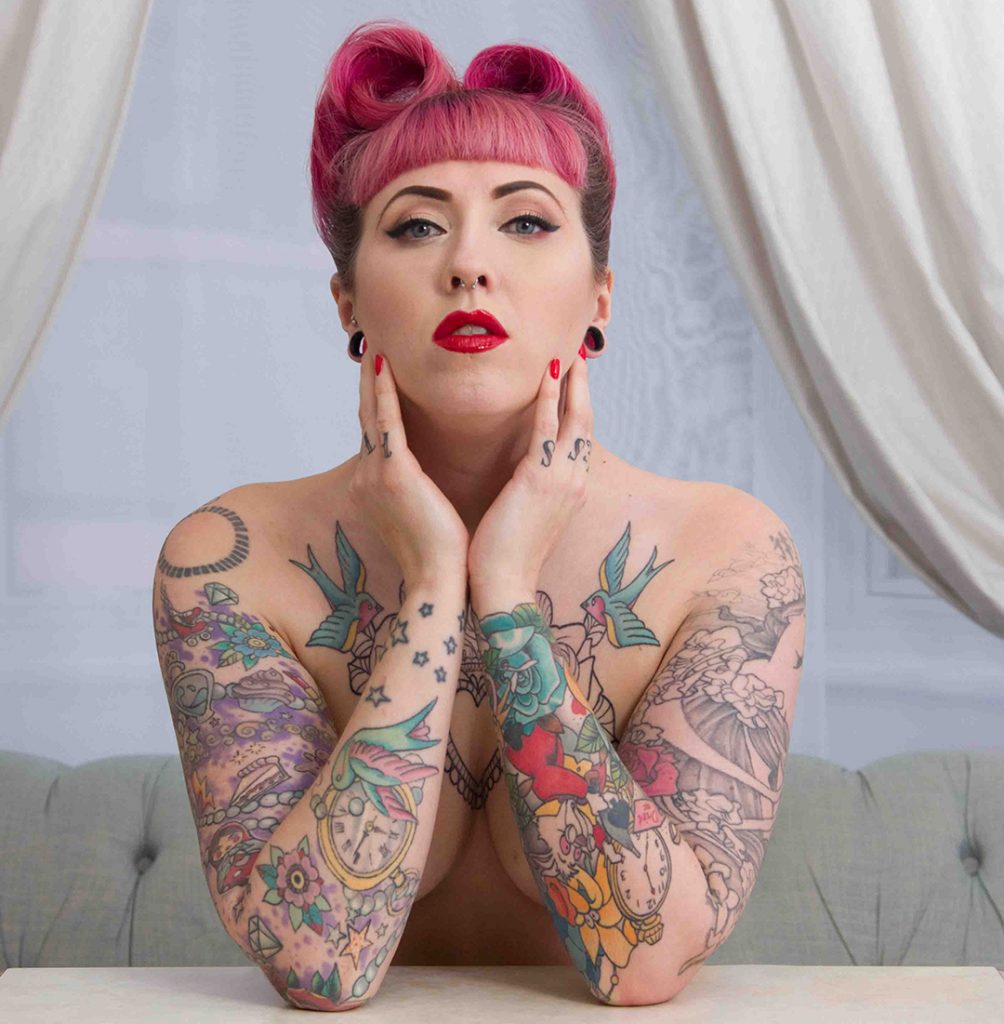 Empowered head and shoulder tattoo portrait, 40s styled pink hair.